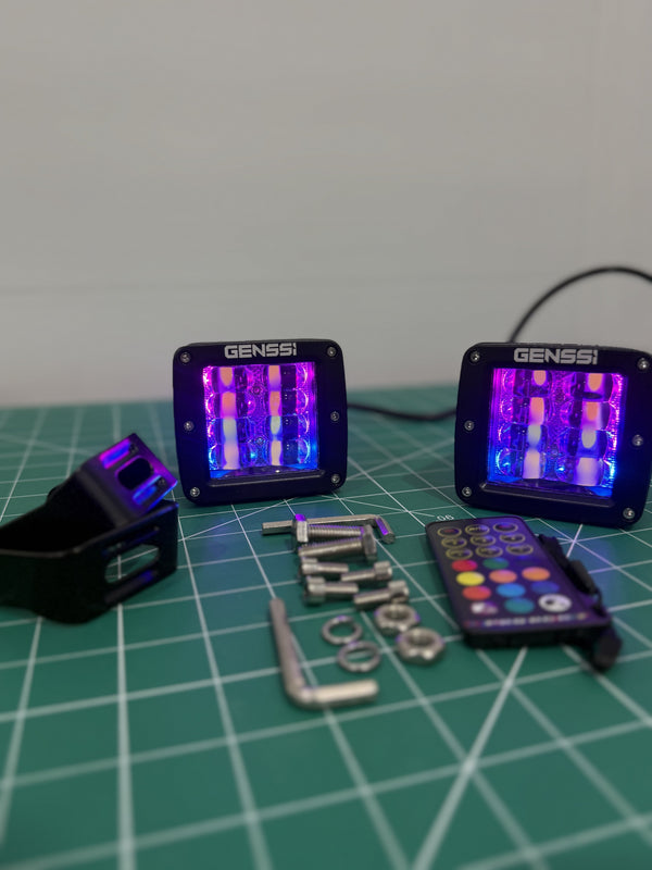 2-piece 24W RGB chase LED pod lights showing purple chase mode with remote and hardware