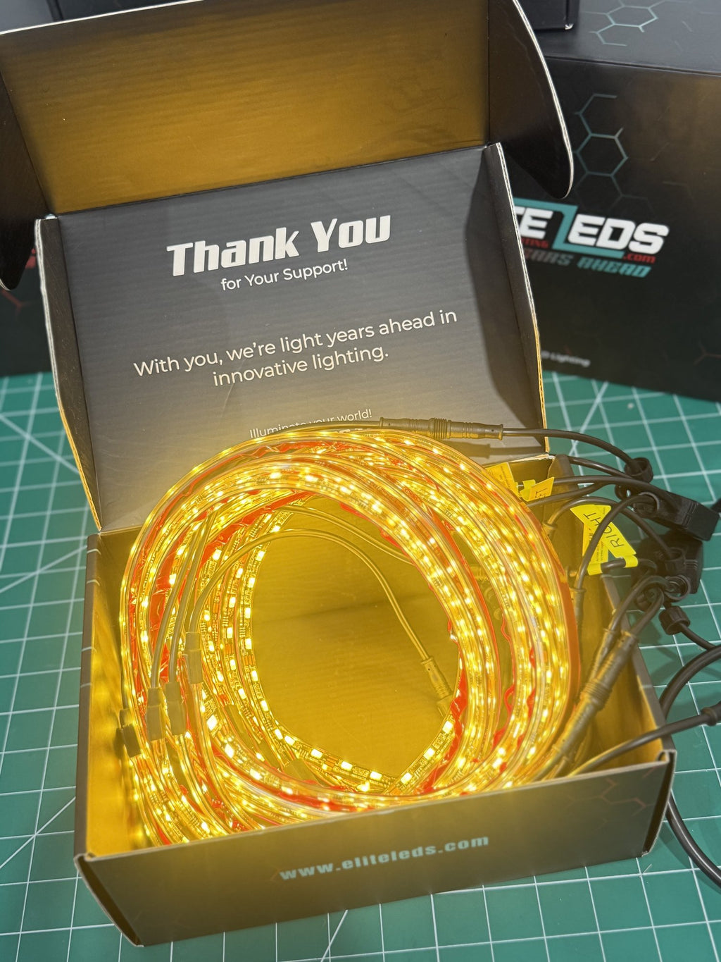 White underglow kit in Elite LEDs premium packaging with warm white LED strips illuminated