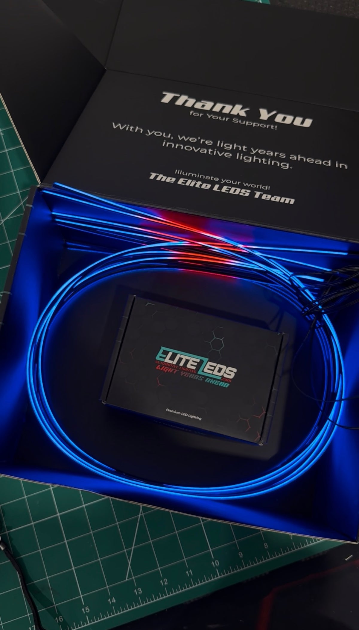 AMB-ELITE-8 kit unboxing showing Elite LEDs premium packaging with blue fiber optic strands